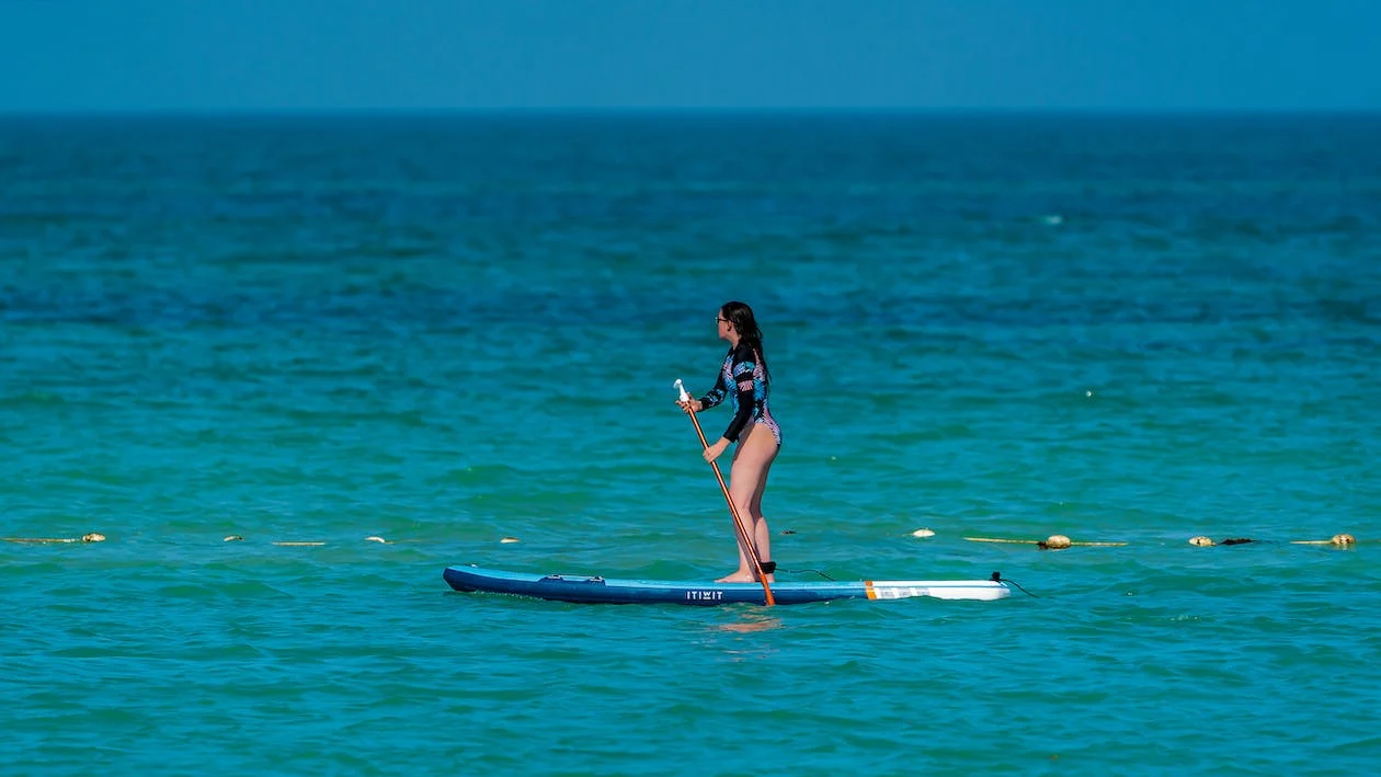 a woman paddleboarding