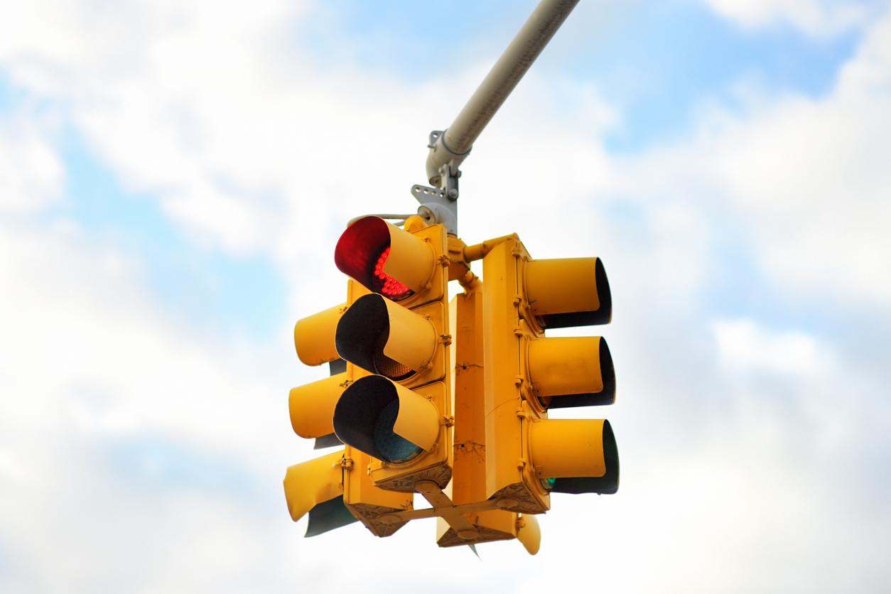 a yellow traffic light hanging 