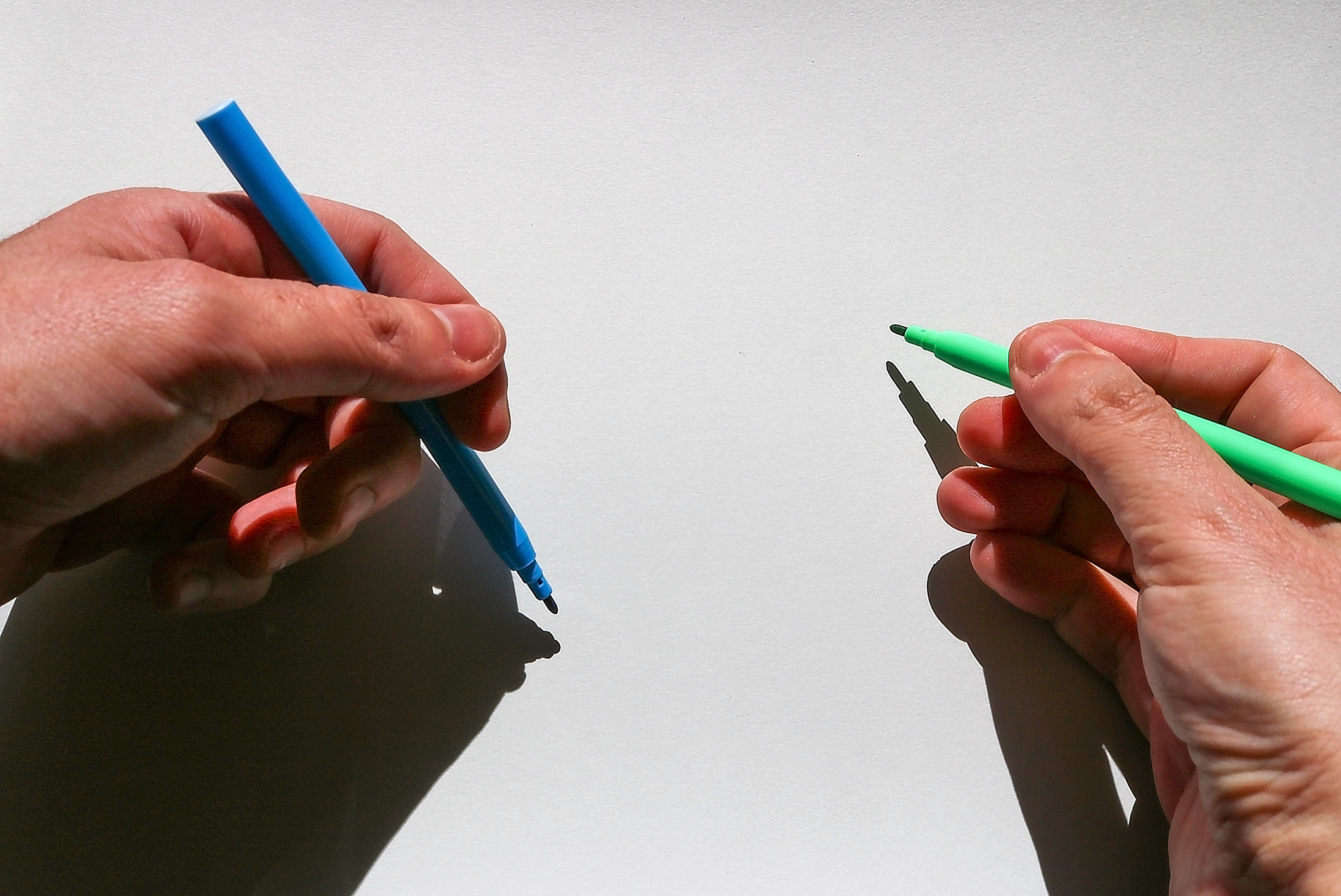 an ambidextrous person holding two markers
