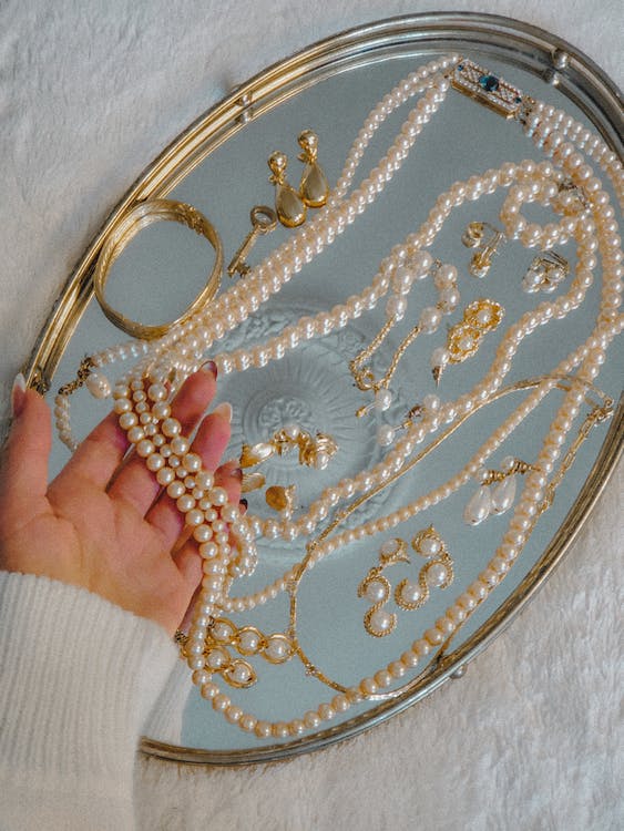 pearl necklace lying on a silver tray
