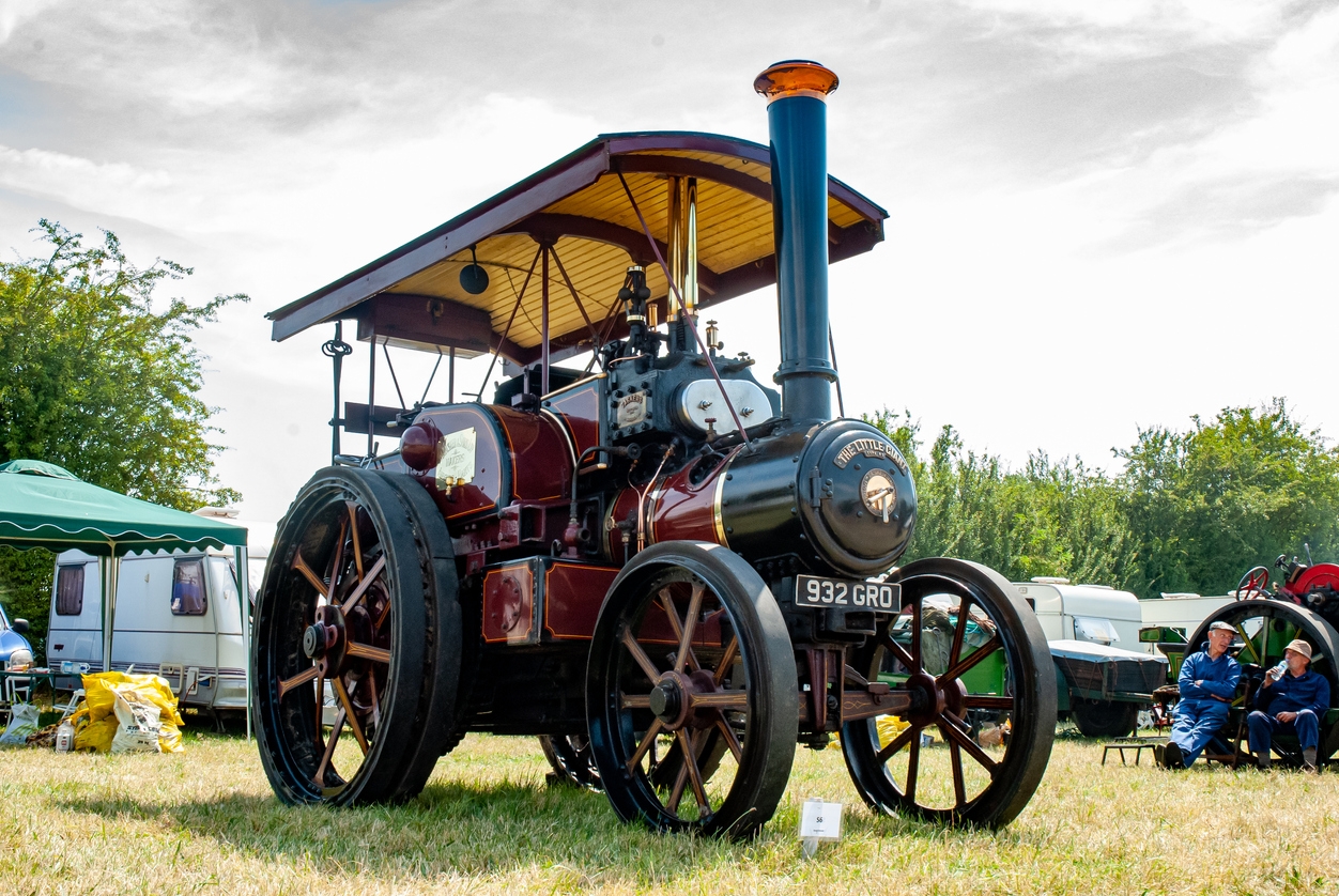 A traction engine parade at a steam rally of vintage road rollers