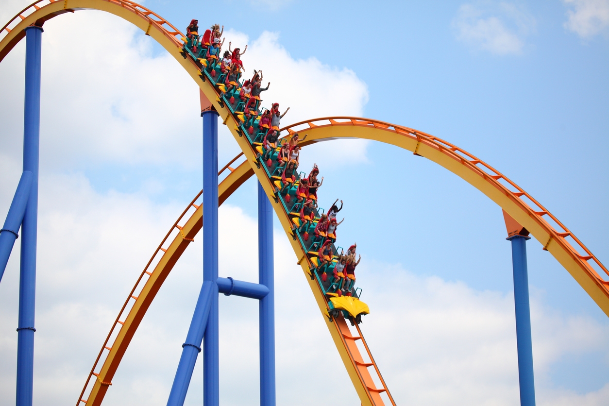 people riding a steel roller coaster 