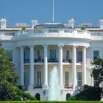 the White House pictured against blue sky