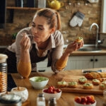 Woman tasting the food she cooked