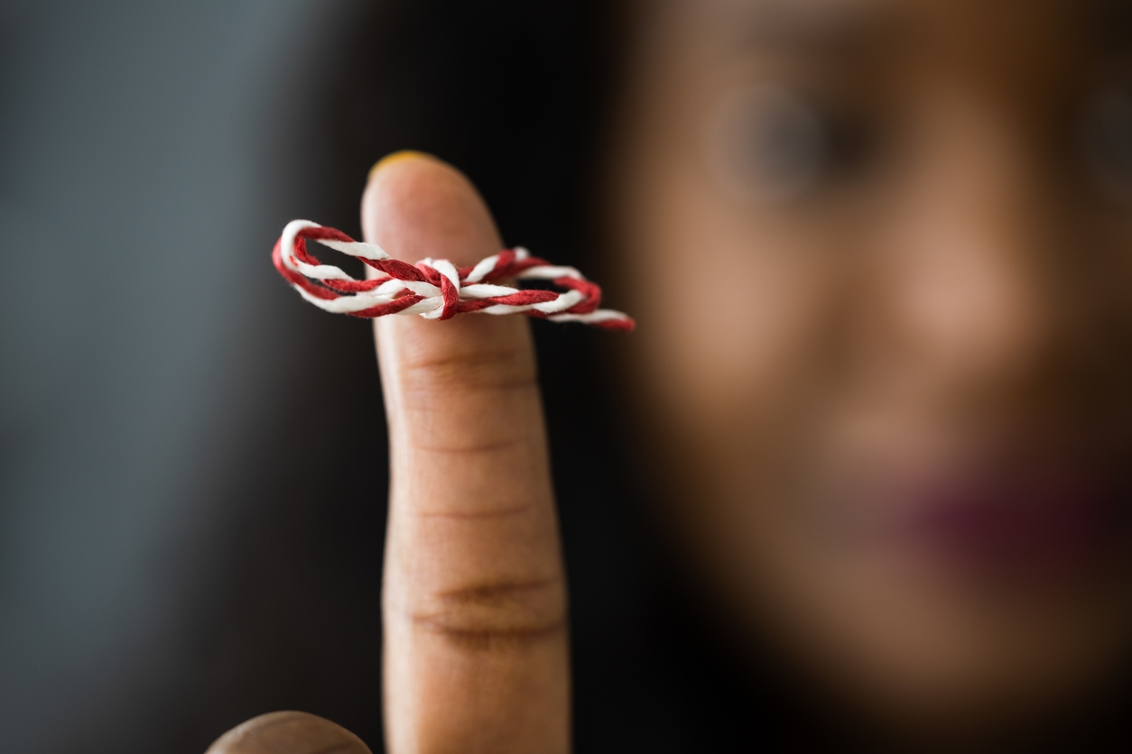 Woman with a memory ribbon around her finger